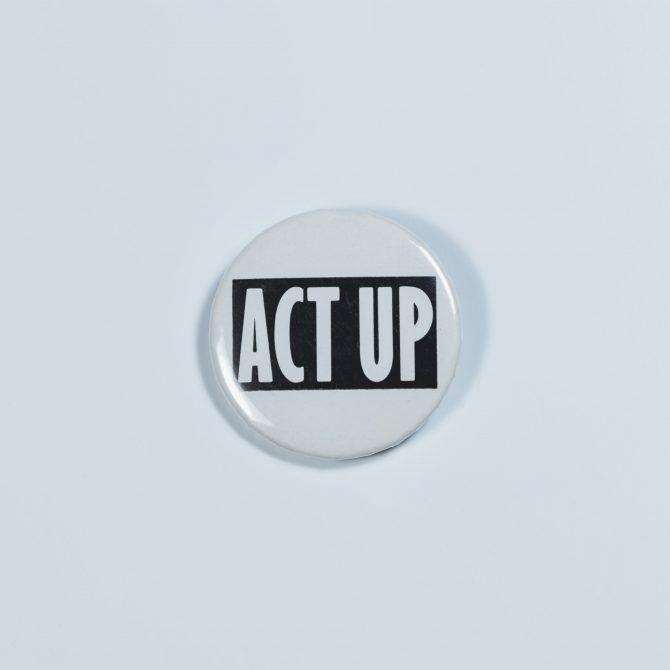 Button reading "ACT UP," referring to the ACT UP organization