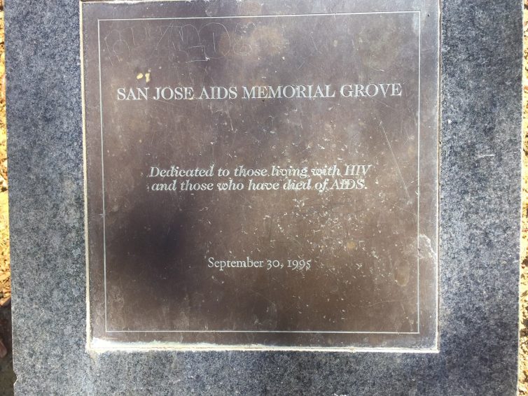 The San Jose AIDS Memorial Grove dedication plaque. It reads, "Dedicated to those living with HIV and those who have died of AIDS. September 30, 1995."