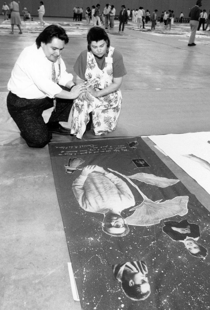 Folks viewing the AIDS memorial quilt at the Tom McEnery Convention Center hosted by ARIS. Photograph from the Ted Sahl Archives at SJSU.