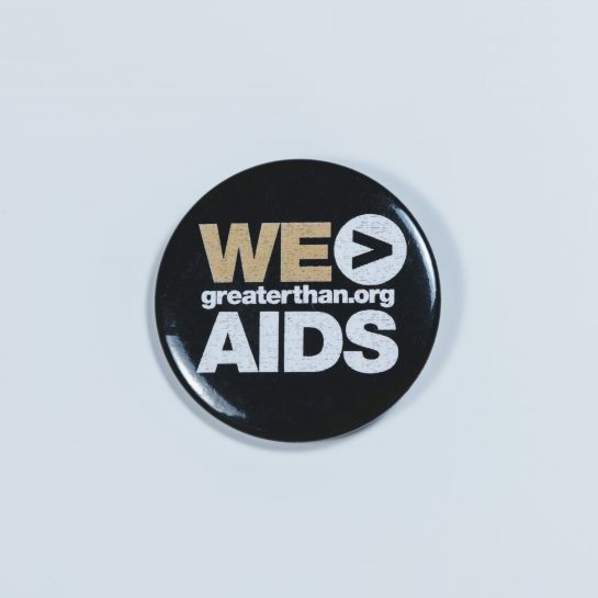 Button reading We > AIDS, greaterthan.org